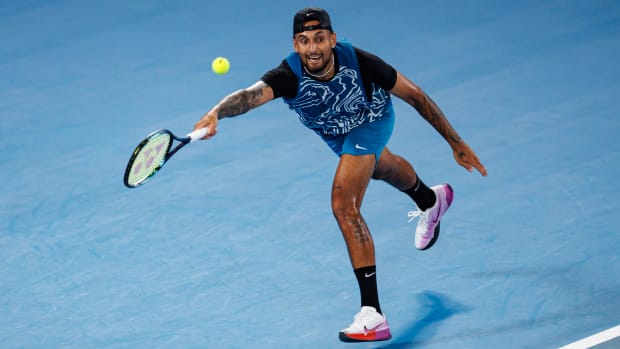 Nick Kyrgios of Australia hits a shot during an exhibition practice match against Novak Djokovic.